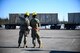 U.S. Air Force Airman 1st Class Kameron Page, left, a 354th Maintenance Squadron (MXS) munitions operations journeyman, and Airman 1st Class Carter Preston, a 354th MXS munitions stockpile apprentice, plan a shipping container unloading during a munitions barge at Eielson Air Force Base, Alaska, April 16, 2021.