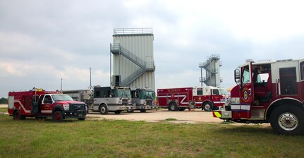 Joint Base San Antonio's 902nd Civil Engineer Squadron Fire Emergency Services, Schertz Fire Rescue, and Cibolo Fire Department vehicles surround a fire training facility at Joint Base San Antonio-Randolph, Texas, April 12, 2021.