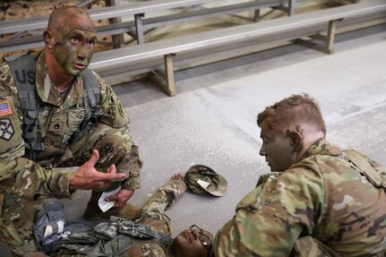 U.S. Army Reserve Staff Sgt. Jonathon P. Chacon, civil affairs specialist with the 426th Civil Affairs Battalion, Upland, Calif., talks through evaluating “casualty” Staff Sgt. Valery Valtrain, an intelligence analyst with the 151st Theater Information Operations Group, Fort Totten, N.Y., as team member, Spc. Timothy J. Lowitzer, a civil affairs specialist with the 1001st Civil Affairs and Psychological Operations Training Company, Trenton, N.J., looks on. The team ran through several drills prior to navigating the Medical Simulation Training Facility (MSFT) training lanes as part of the 2021 U.S. Army Civil Affairs and Psychological Operations Command (Airborne) Best Warrior Competition at Fort Jackson, S.C., held April 8-11. Competitors navigated the lanes individually, providing immediate combat life-saving measures to a simulated casualty while being evaluated on their medical evacuation techniques and casualty care skills. The USACAPOC(A) BWC enhances basic Soldier skills and individual readiness tasks needed to adapt to the ever changing operational environment. The top Soldier and Non-commissioned Officer who earn the title of "Best Warrior" will go on to represent USACAPOC(A) at the U.S. Army Reserve Best Warrior Competition later this summer at Ft. McCoy, Wisconsin.