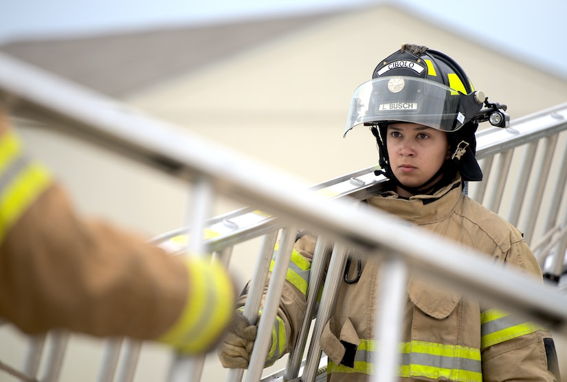 Linda Busch-Mendez, Cibolo Fire Department firefighter, holds a ladder during training at Joint Base San Antonio-Randolph, Texas, April 12, 2021.