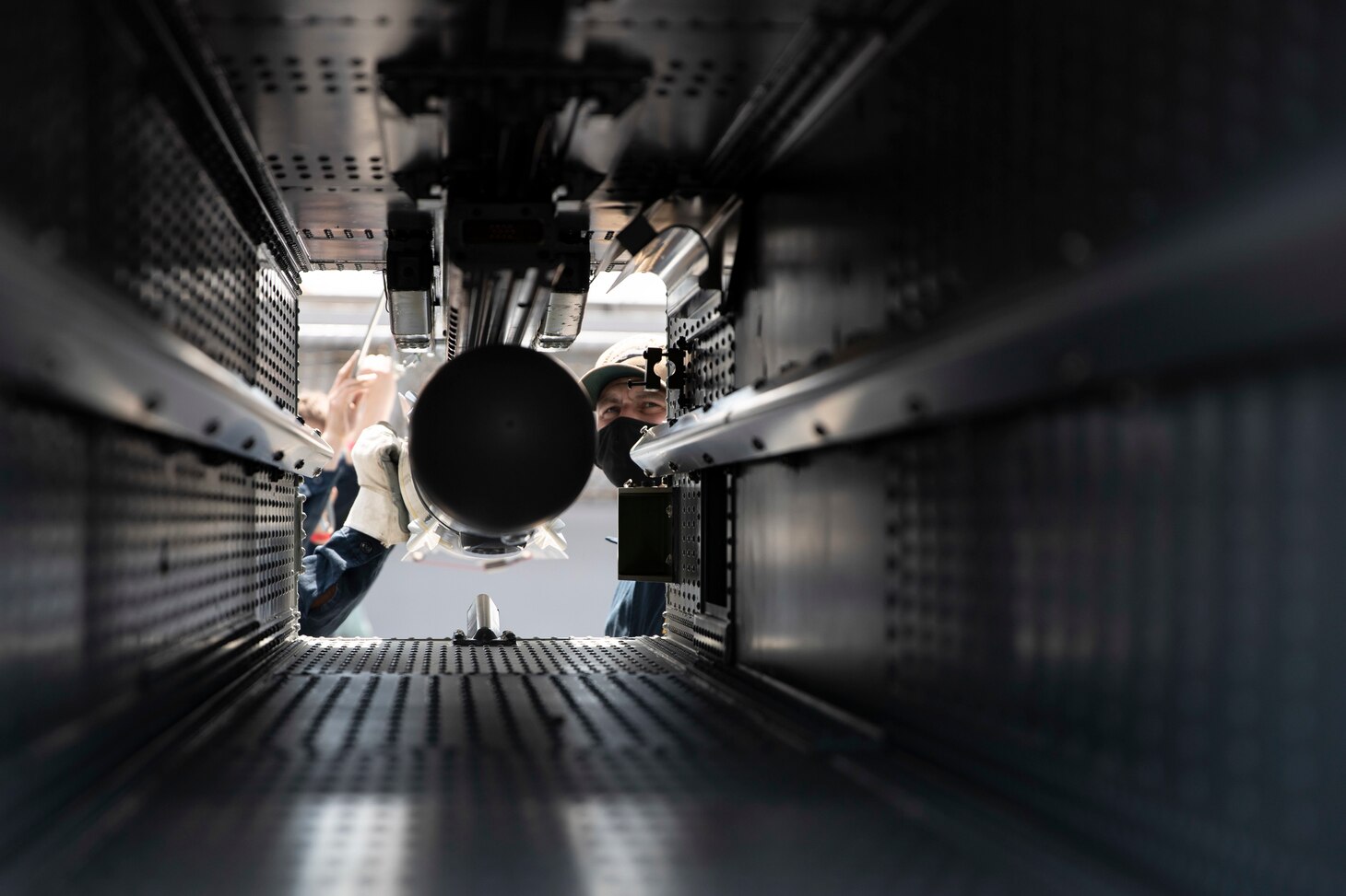 Sailors assigned to USS Gerald R. Ford (CVN 78) load an Evolved Sea Sparrow Missile (ESSM) into a missile launcher during an ammunition onload.