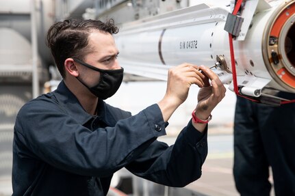 Fire Controlman 2nd Class Anthony Anadon, from Stockton, California, assigned to the aircraft carrier USS Gerald R. Ford (CVN 78), prepares an Evolved Sea Sparrow Missile (ESSM) for upload into a missile launcher during an ammunition onload.