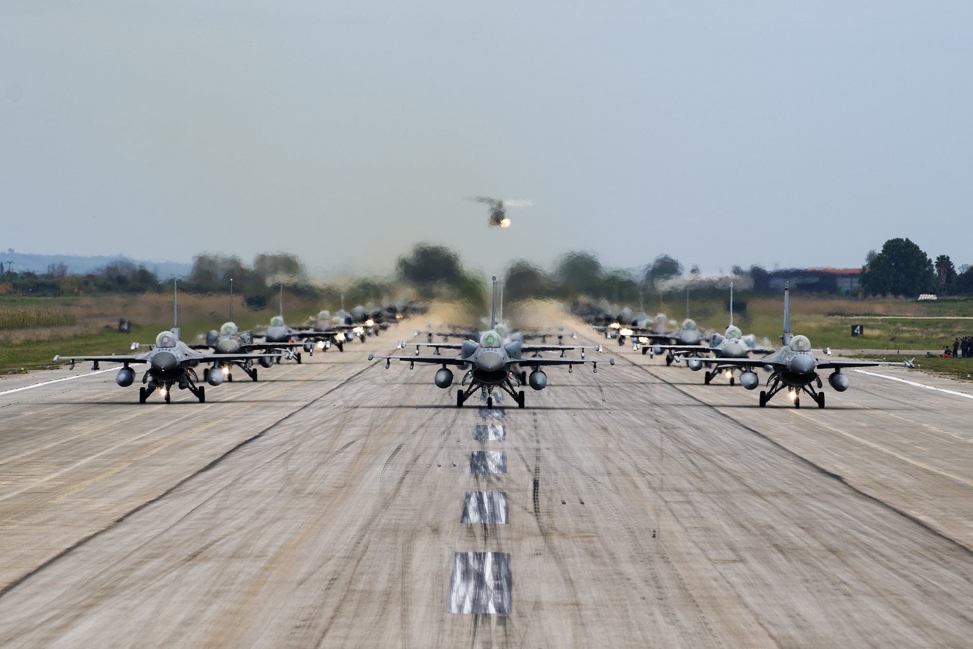 Aircraft from several countries participating in INIOCHOS 21 perform an elephant walk at Andravida Air Base, Greece, April 18, 2021. The 510th Fighter Squadron participated in INIOCHOS 21, a Hellenic air force-led, large force flying exercise. Participation in INIOCHOS 21 allowed U.S. Air Force pilots the opportunity to develop and improve air readiness and interoperability with allied and partner air forces. (U.S. Air Force photo by Airman 1st Class Thomas S. Keisler IV)