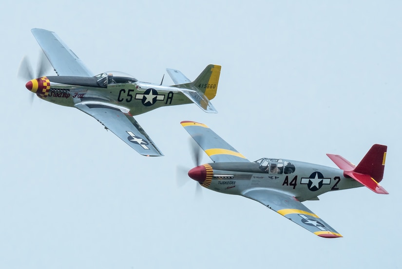 A two-ship P-51 Mustang formation performs an aerial demonstration over Bowman Field in Louisville, Ky., April 17, 2021, as part of the Thunder Over Louisville air show. The top aircraft, nicknamed Swamp Fox, is now privately owned but once belonged to the active inventory of the Kentucky Air National Guard following World War II. (U.S. Air National Guard photo by Dale Greer)