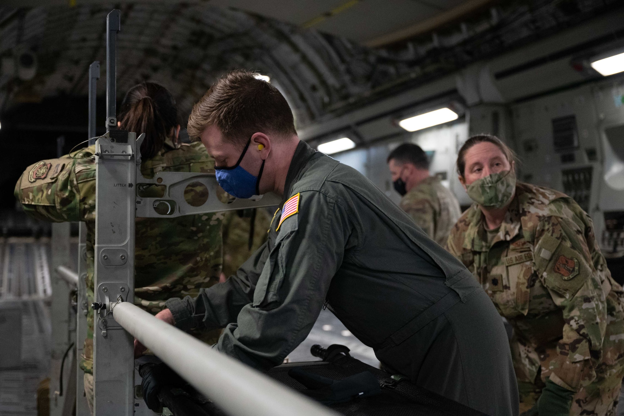 Staff Sgt. James Bittel, 775th Expeditionary Aeromedical Evacuation Flight aeromedical technician, adjusts a litter onto a stanchion rack on a C-17 Globemaster III at Dover Air Force Base, Delaware, March 16, 2021. Aerospace Medical Service specialists provide essential care in multiple medical roles by assisting doctors and caring for patients in a wide range of situations. (U.S. Air Force photo by Airman 1st Class Faith Schaefer)