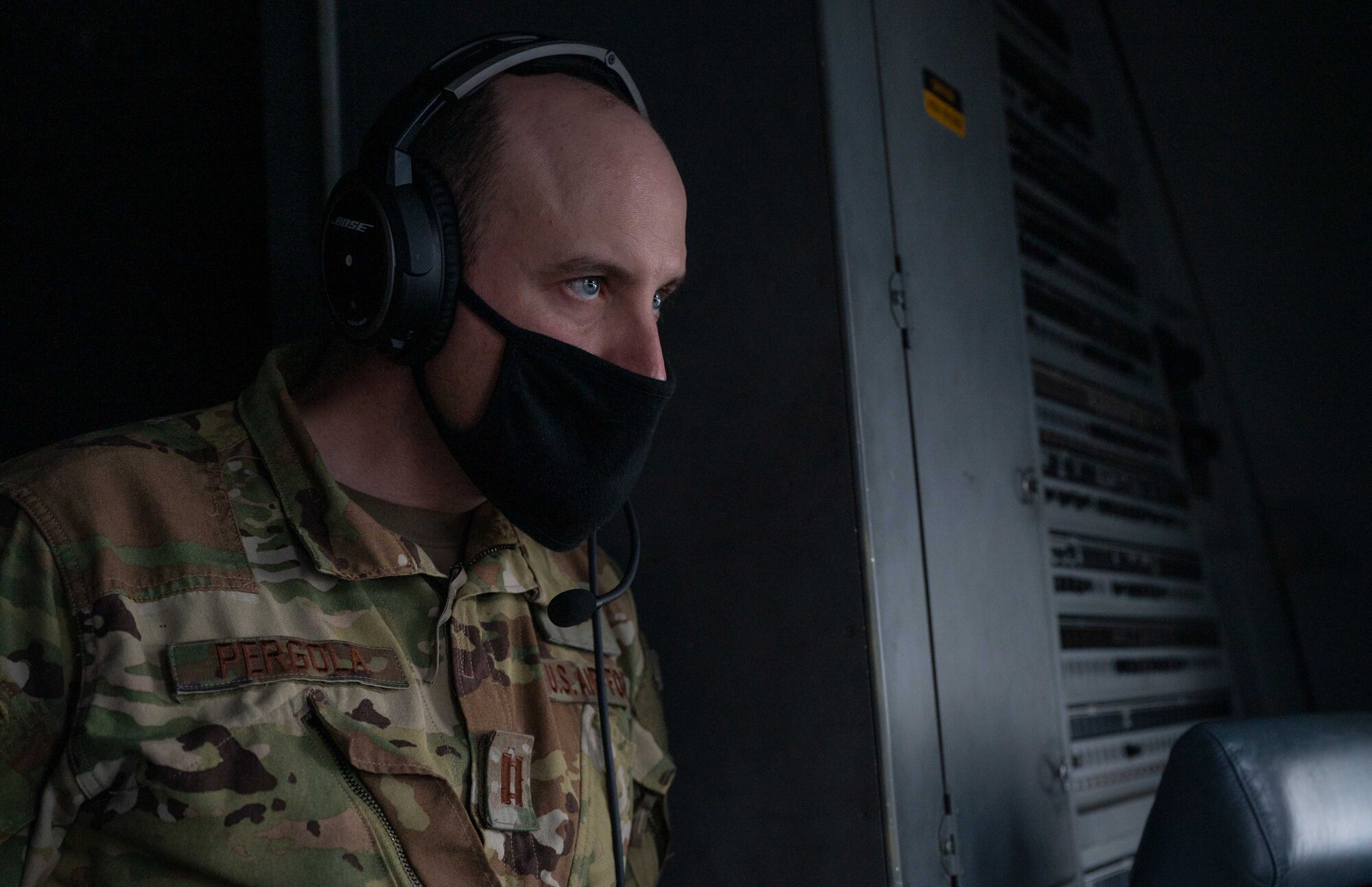 Capt. Anthony Pergola, 3rd Airlift Squadron pilot, looks out the window of a C-17 Globemaster III during a flight from Dover Air Force Base, Delaware, March 16, 2021. The 3rd AS constantly trains to provide global reach with unique, outsized and oversized airlift capability. (U.S. Air Force photo by Airman 1st Class Faith Schaefer)