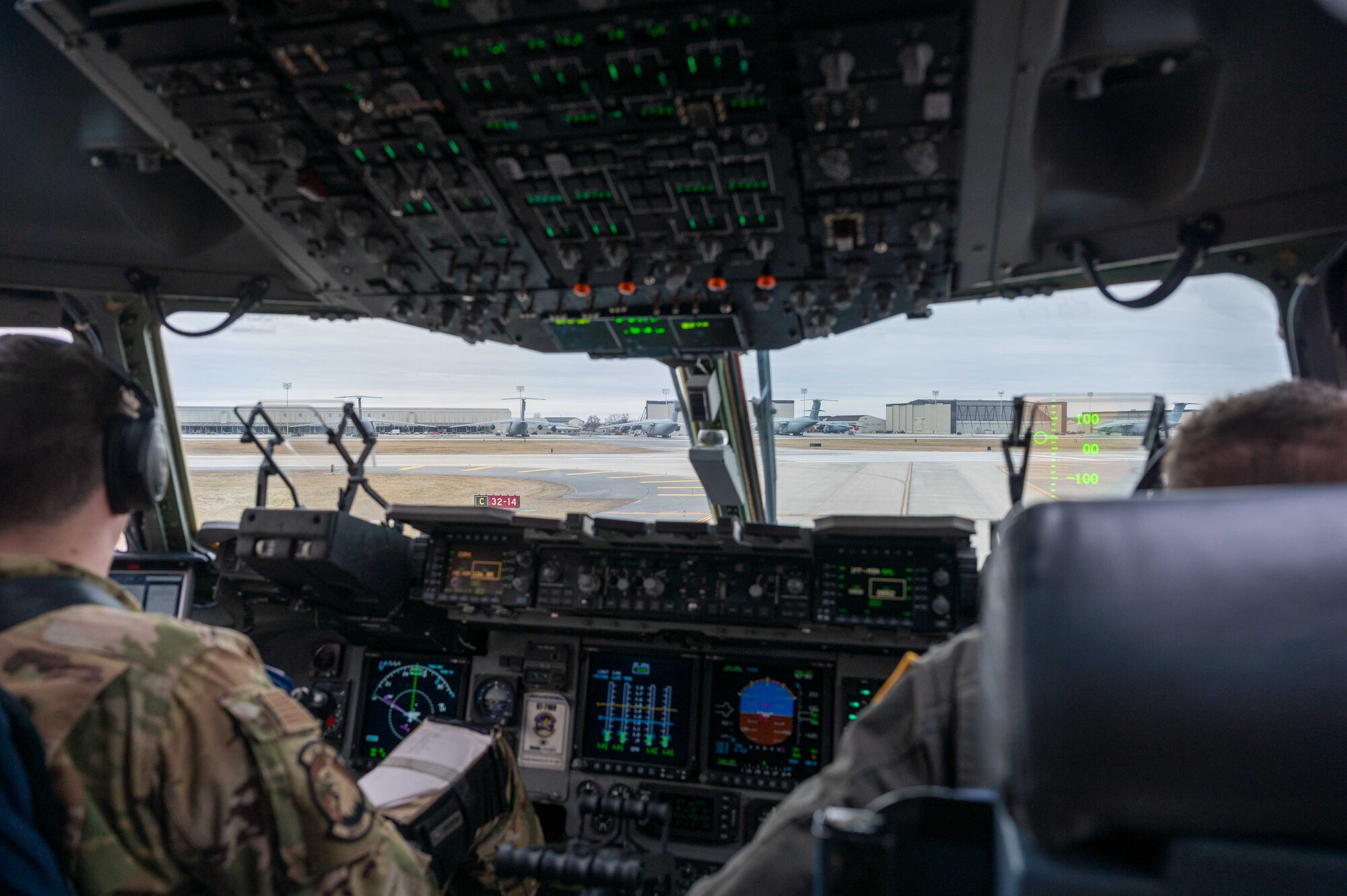 Maj. Casey Boley, left, and Capt. Corey Landis, both 3rd Airlift Squadron pilots, perform a preflight check before takeoff at Dover Air Force Base, Delaware, March 16, 2021. The 3rd AS constantly trains to provide global reach with unique, outsized and oversized airlift capability. (U.S. Air Force photo by Airman 1st Class Faith Schaefer)