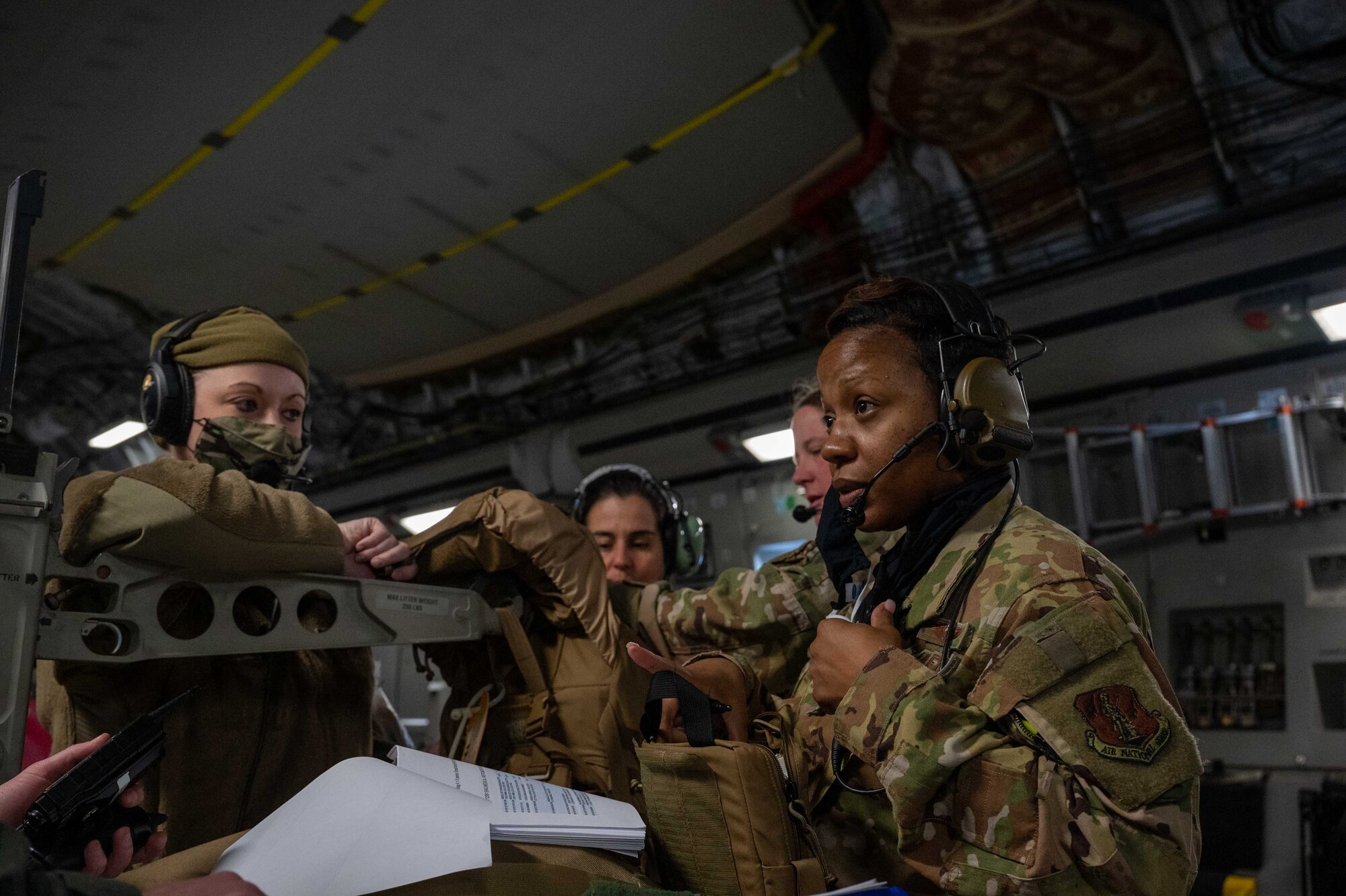 Capt. Kemeshia Greene, 775th Expeditionary Aeromedical Flight officer in charge, explains the contents of a medical bag during a training flight on a C-17 Globemaster III over Maine, March 16, 2021. Aerospace Medical Service specialists provide essential care in multiple medical roles by assisting doctors and caring for patients in a wide range of situations. (U.S. Air Force photo by Airman 1st Class Faith Schaefer)