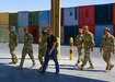 U.S. Army Col. Michael F. LaBrecque, commander, 401st Army Field Support Brigade, and Army Field Support Battalion-Qatar leadership, tour an empty pavilion previously used for maintenance and services, at Camp As Sayliyah, Qatar, Apr. 6.  AFSBn-Qatar is currently in the process of complete deactivation as part of the U.S. Army Material Command’s “Middle East calibration.” (Photo by Capt. Luis Alani, 401st AFSB Public Affairs)