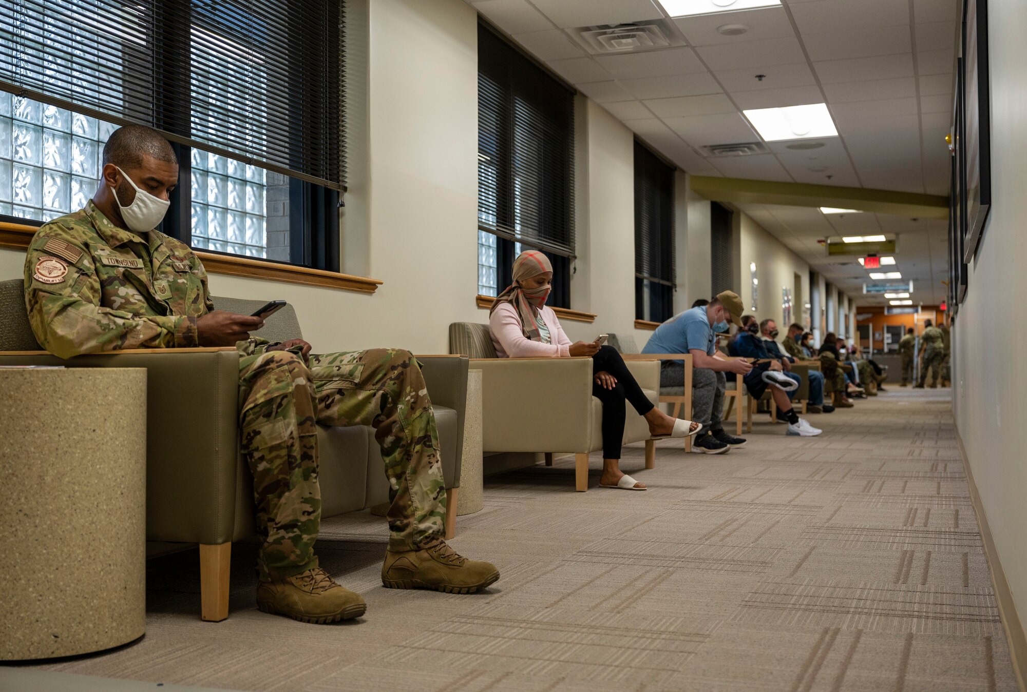 Patients wait in line to receive their first COVID-19 vaccine dose at Dover Air Force Base, Delaware, April 19, 2021. The 436th Medical Group opened vaccination eligibility to Tier 2 patients, which includes all healthy uniformed personnel and TRICARE beneficiaries. (U.S. Air Force photo by Airman 1st Class Cydney Lee)