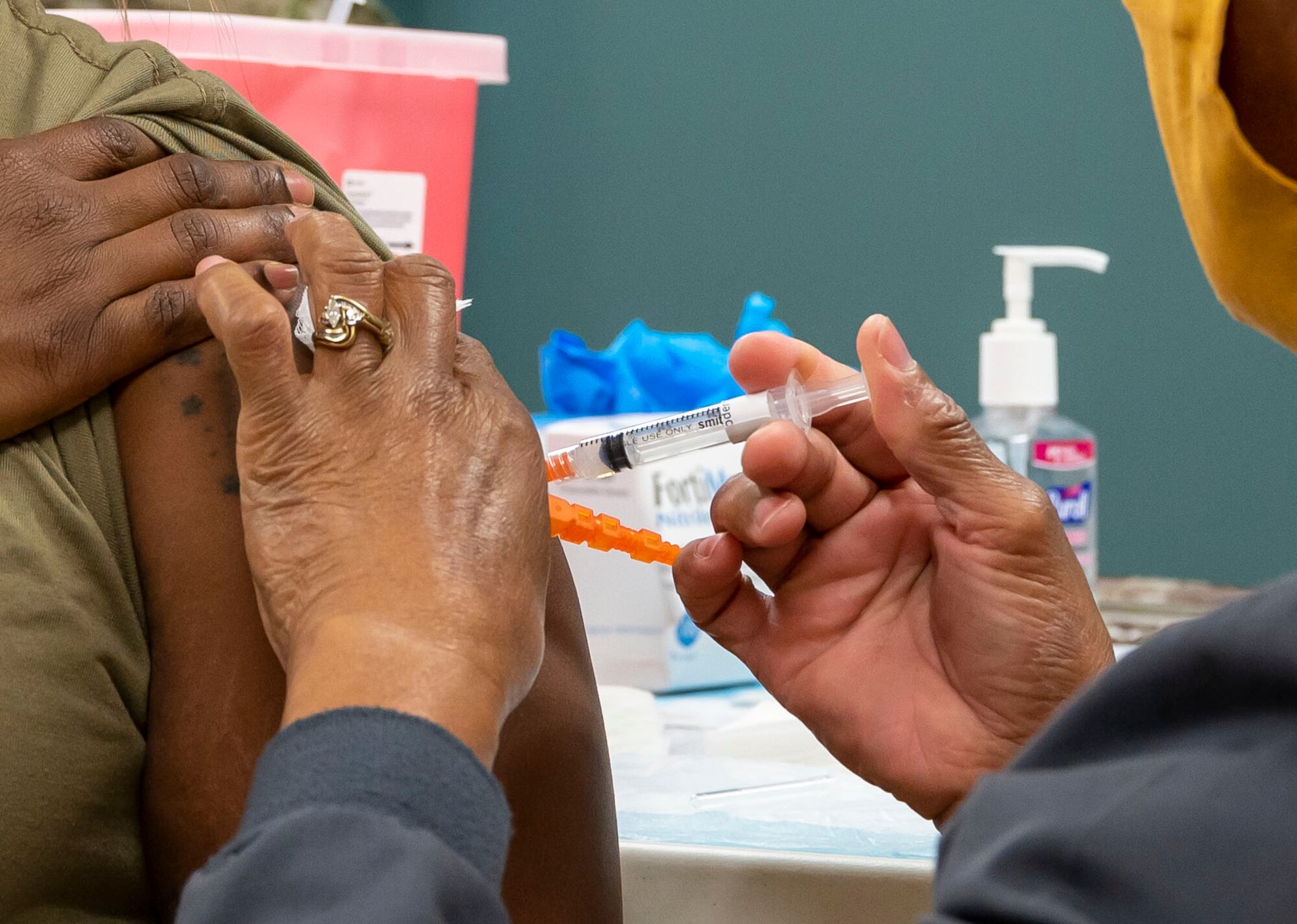 Master Sgt. Ashley Daniel, 436th Security Forces installation security section chief, receives her first dose of the COVID-19 vaccine from Gabriella Dillard, 436th Medical Group nurse, at Dover Air Force Base, Delaware, April 19, 2021. The 436th MDG opened vaccination eligibility to Tier 2 patients, which includes all healthy uniformed personnel and TRICARE beneficiaries. (U.S. Air Force photo by Airman 1st Class Cydney Lee)