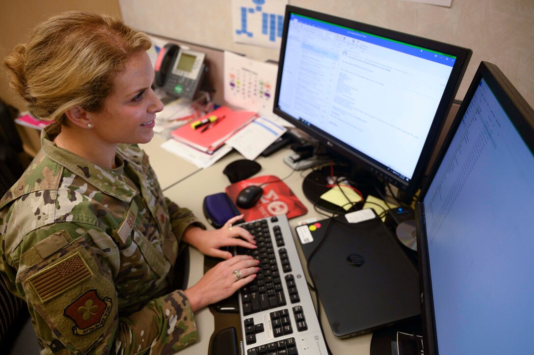 Photo of Airman working at her desk