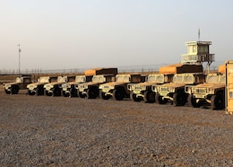 Humvees bask in the Camp Arifjan, Kuwait, sunset parked April 13, 2021 in the maintenance yard stood up by Fort Knox, Kentucky, based 1st Theater Sustainment Command Soldiers, as part of their expeditionary command post validation exercise. The ECP validation exercise included a fully capable sustainment operational center, where 1st TSC commanding general Maj. Gen. Joseph P. Sullivan, was briefed by his staff, subordinate and partner units from across the U.S. Central Command area of responsibility and in the United States. (U.S. Army photo by Staff Sgt. Neil W. McCabe)