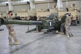 Soldiers from the 1st Theater Sustainment Command, Operational Command Post observe equipment which has been staged as part of the 401st Army Field Support Battalion-Kuwait’s and the Army’s Prepositioned Stock program at Camp Arifjan, Kuwait on April 3, 2021. (U.S. Army photo by Capt. Elizabeth Rogers)