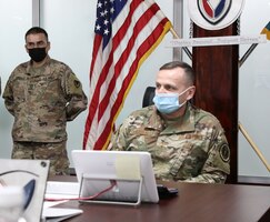 Air National Guard Brig. Gen. Darrin E. Slaten, the chief of office of military cooperation at the U.S. Embassy to Kuwait, receives a briefing concerning the Army Preposition Stock Program from Lt. Col. Nichole Vild, commander of the 401st Army Field Support Battalion-Kuwait at Camp Arifjan, Kuwait. (U.S. Army photo by Capt. Elizabeth Rogers)