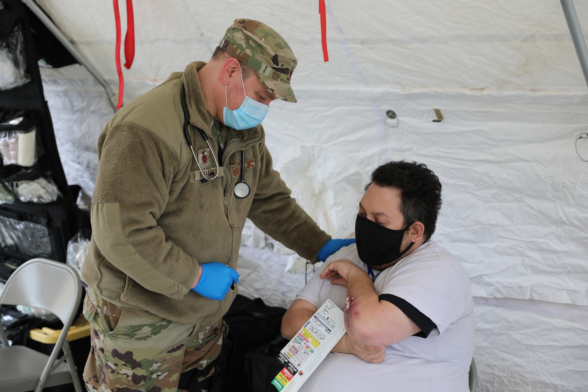 Maj. Robert Holland, a doctor assigned to the New York Aiir National Guard's 105th Medical Group, practices triage and treatment with a civiilain role-player during a Homeland Response Force collective training event in East Amherst, New York on April 17. The 105th Medical Group serves as part of the medical support element of the FEMA Region II HRF, tasked with response in the first hours and days of natural or manmade disasters. (Army National Guard Photo by Capt. Avery Schneider)
