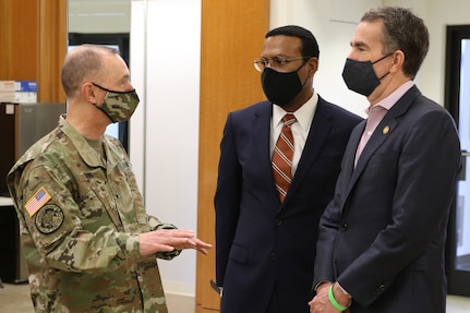 Brig. Gen. James W. Ring provides an update to Virginia Governor Ralph Northam and Norfolk Mayor Kenny Alexander March 31, 2021,at a community vaccination clinic at the Military Circle Mall in Norfolk, Virginia. Ring serves as a dual-status commander for Title 10 and Title 32 forces supporting the COVID-19 response in Virginia.