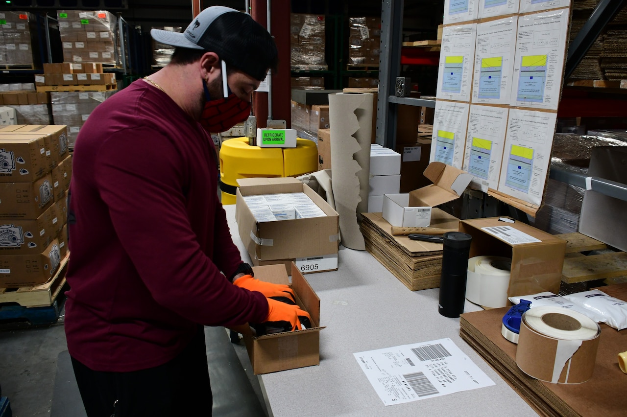 A man prepares a package.