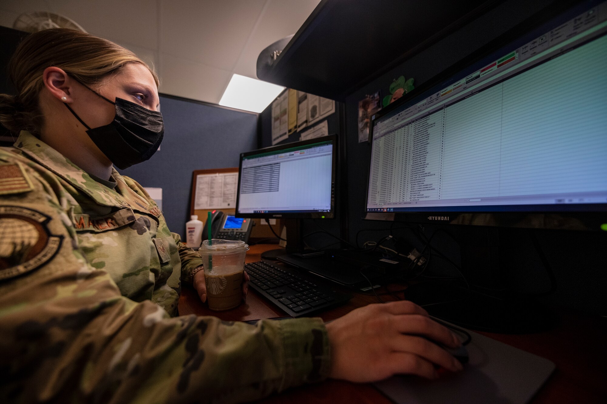 A female Airman works at her desk.