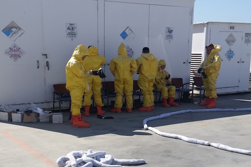 People put on hazardous materials suits.