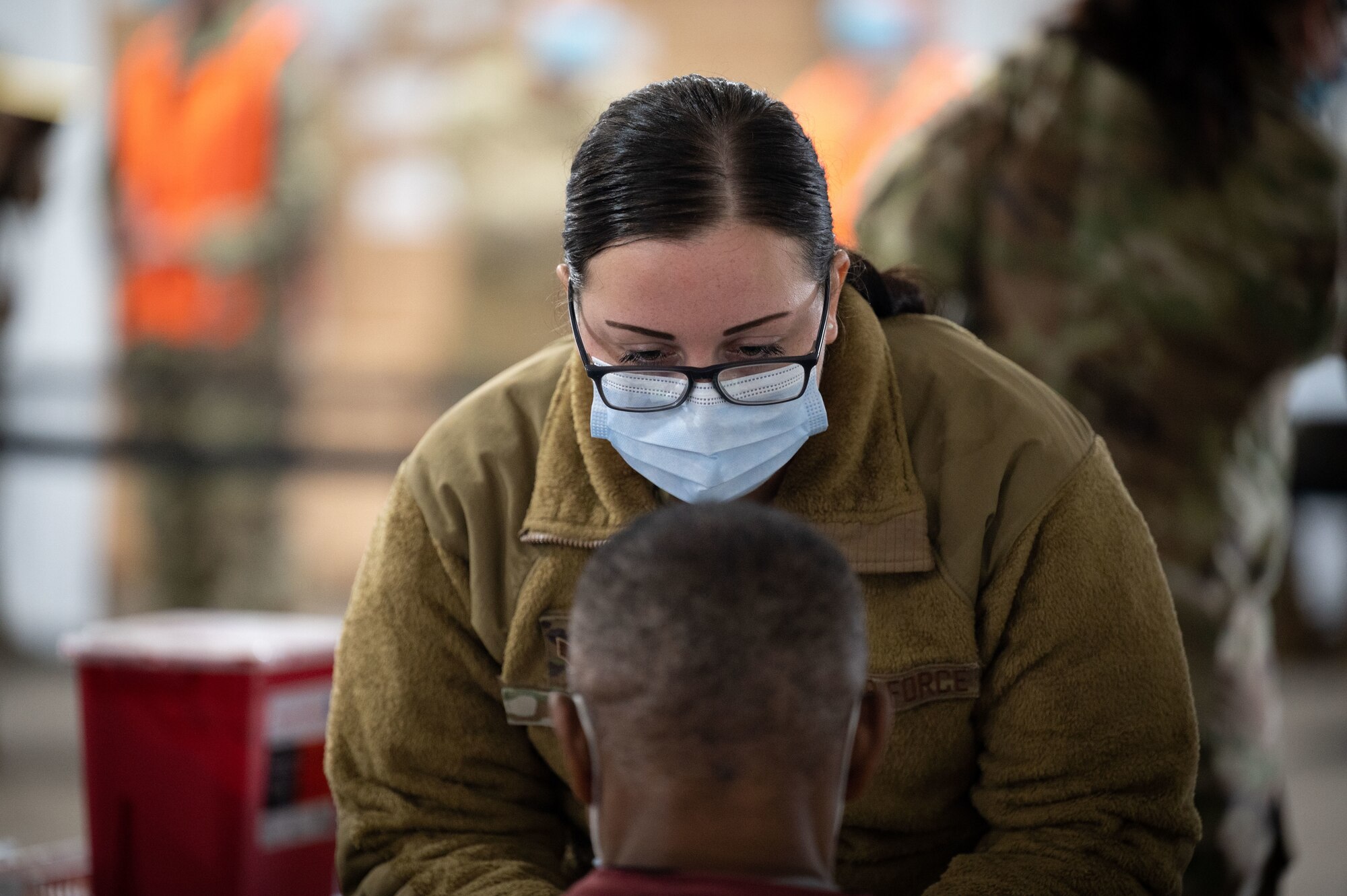 An Air Force medical technician speaks with a Tampa community member.