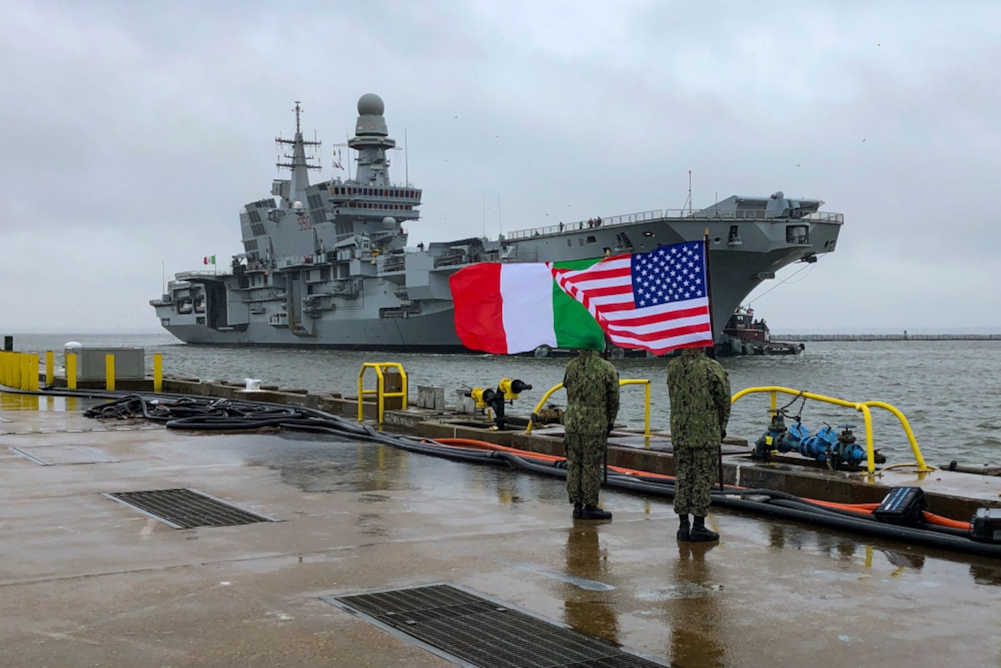 U.S. Sailors, assigned to the aircraft carrier USS John C. Stennis (CVN 74), greet the Italian Navy flagship, aircraft carrier ITS Cavour (CVH 550), as it arrives at Naval Station Norfolk, Virginia, Feb. 13, 2021. The Cavour’s visit is part of a series of operations alongside U.S. military assets to attain the Italian Navy’s “Ready for Operations” certification to safely land and launch F-35B aircraft, U.S. 2nd Fleet exercises operational authorities over assigned ships, and landing forces on the East Coast and the Atlantic.
