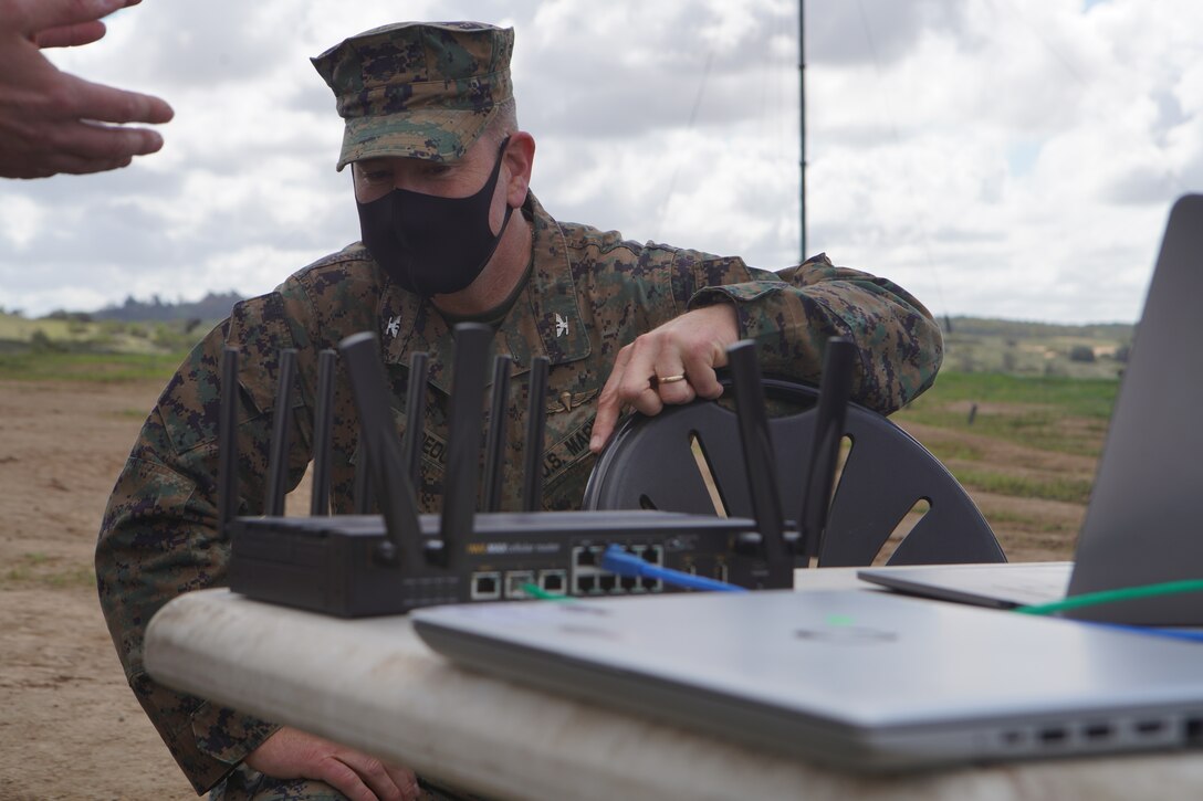 U.S. Marine Corps Col. Brian Rideout, commanding officer, I Marine Expeditionary Force Information Group, inspects the routing system for the Cloud Layered Obfuscation Application Kit (CLOAK) during a practical exercise at Marine Corps Base Camp Pendleton, California, March 9, 2021. Project CLOAK uses commercial cloud computing resources to enhance the Marine Corps network system and secures global infrastructure. (U.S. Marine Corps photo by Lance Cpl. Aidan Hekker)