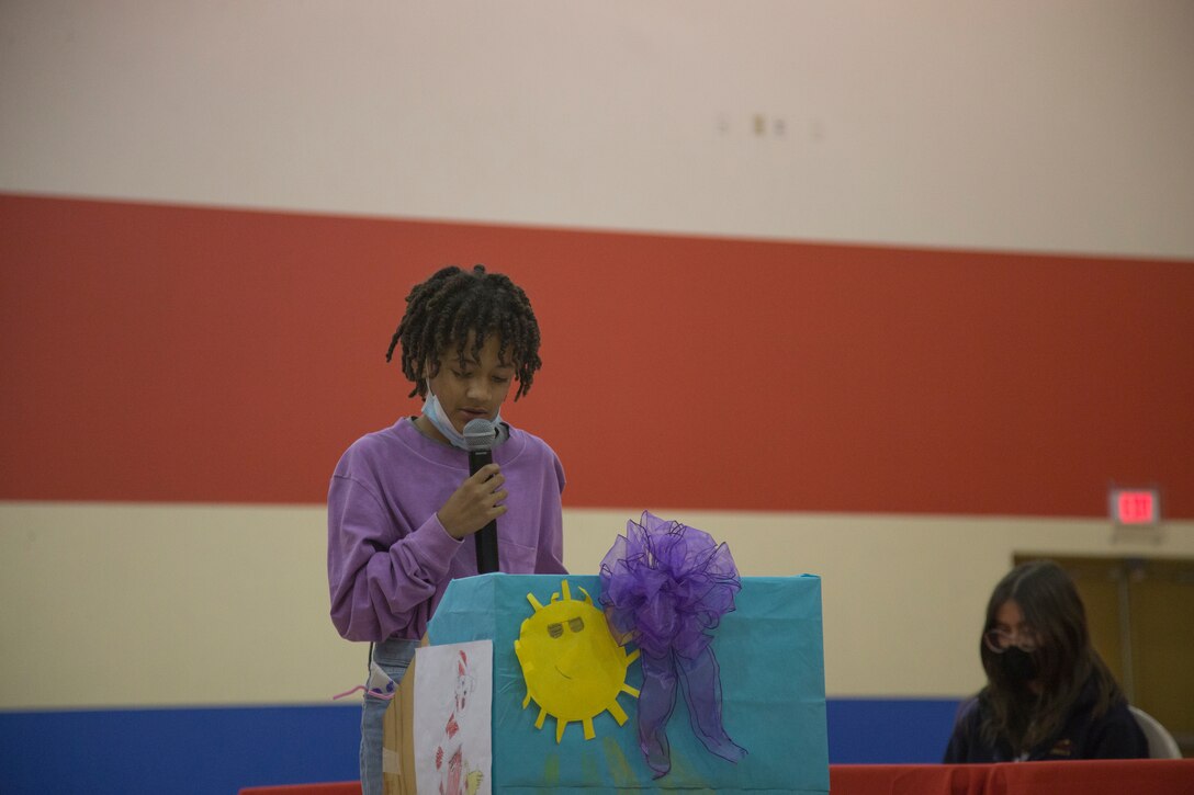 A child shares his personal experience during a ceremony dedicated to military children at the Youth Center on MCAS Yuma, Ariz., April 14, 2021. The ceremony was held to honor military children by highlighting their unique experiences. (U.S. Marine Corps photo by Cpl. Joseph Exner)