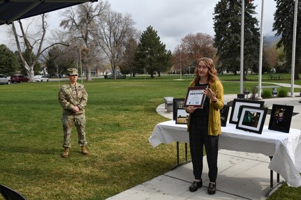 A woman holds an award