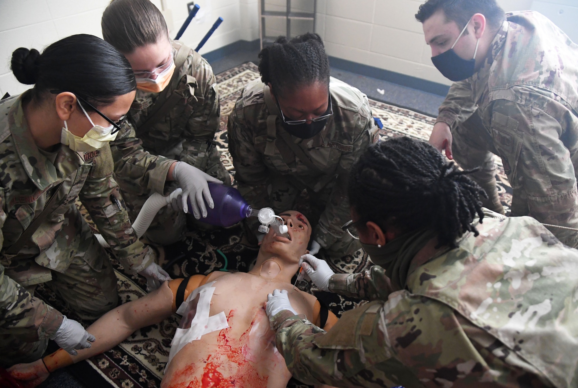 Dragon medics participate in the Tactical Combat Casualty Care training program inside the Locker House at Keesler Air Force Base, Mississippi, March 30, 2021. The training offers hands-on training in a simulated deployed environment using evidence based, life saving techniques and strategies to provide the best trauma care possible on the battlefield. (U.S. Air Force photo by Kemberly Groue)