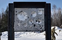 U.S. Air Force Airmen from 354th Civil Engineer Squadron Explosive Ordnance Disposal (EOD) Flight  inspect a gauge stand after a snow mitigation test March 18, 2021 at Eielson Air Force Base, Alaska.
