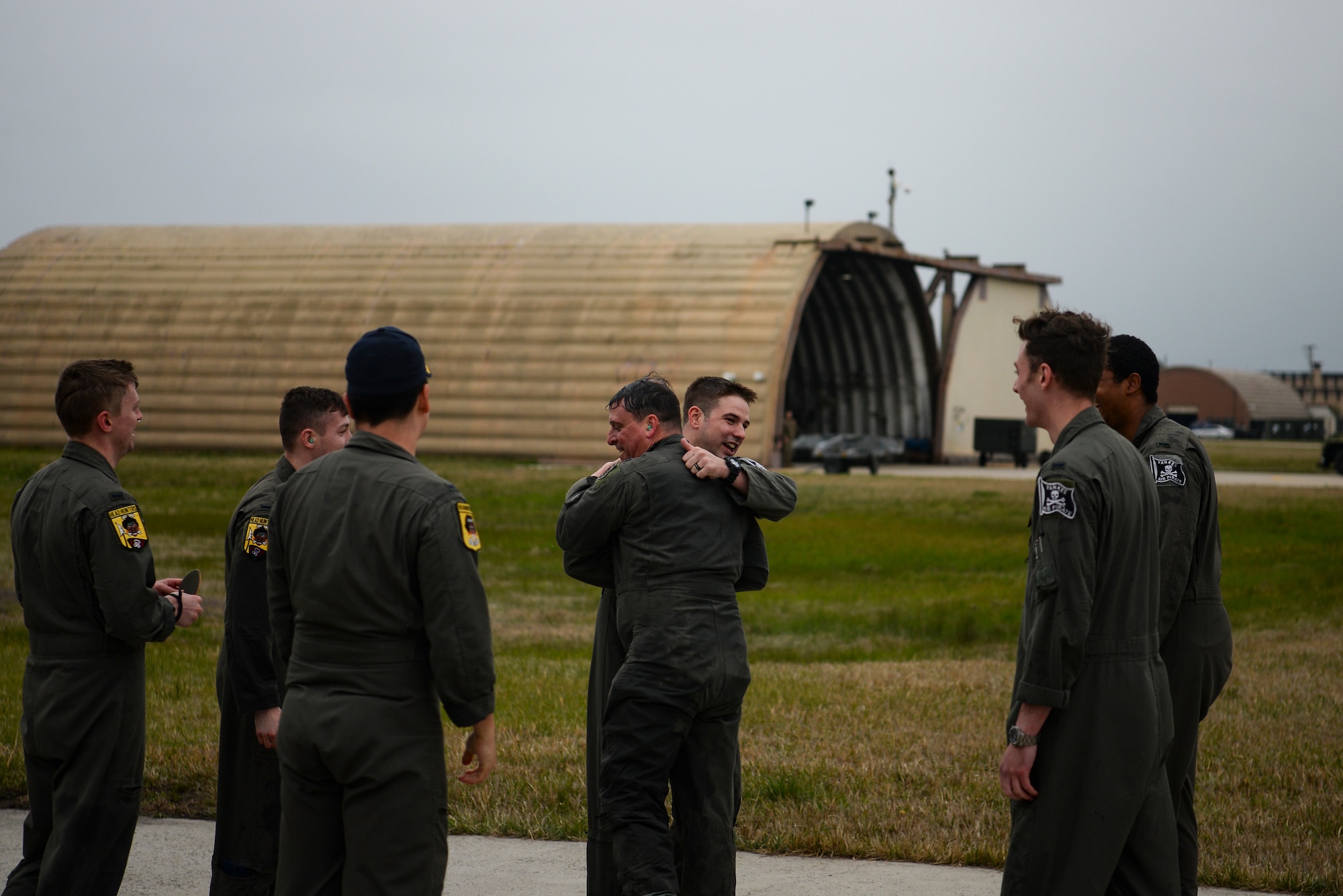 A pilot hugs another pilot.