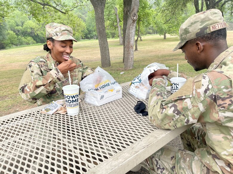 Tech. Sgt. Nessie McCray, 344th Training Squadron, and her son, Airman Basic Jaylen Netterville, 343rd Training Squadron, share lunch at Joint Base San Antonio-Lackland, Texas, April 15, 2021. Both look forward to graduating and beginning their new careers. (U.S. Air Force photo by Agnes Koterba)