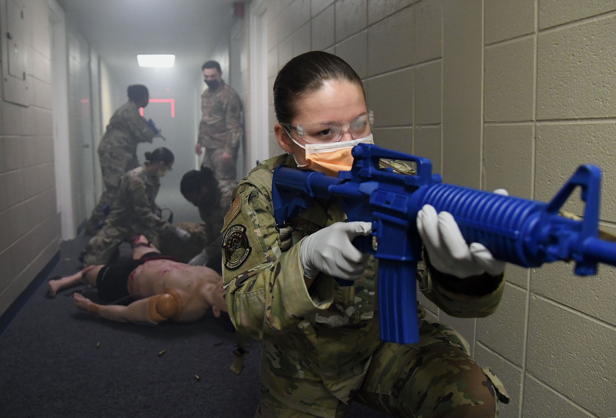 U.S. Air Force Airman 1st Class Andrea Roberts, 81st Medical Support Squadron medical technician, participates in the Tactical Combat Casualty Care training program inside the Locker House at Keesler Air Force Base, Mississippi, March 30, 2021. The training offers hands-on training in a simulated deployed environment using evidence based, life saving techniques and strategies to provide the best trauma care possible on the battlefield. (U.S. Air Force photo by Kemberly Groue)