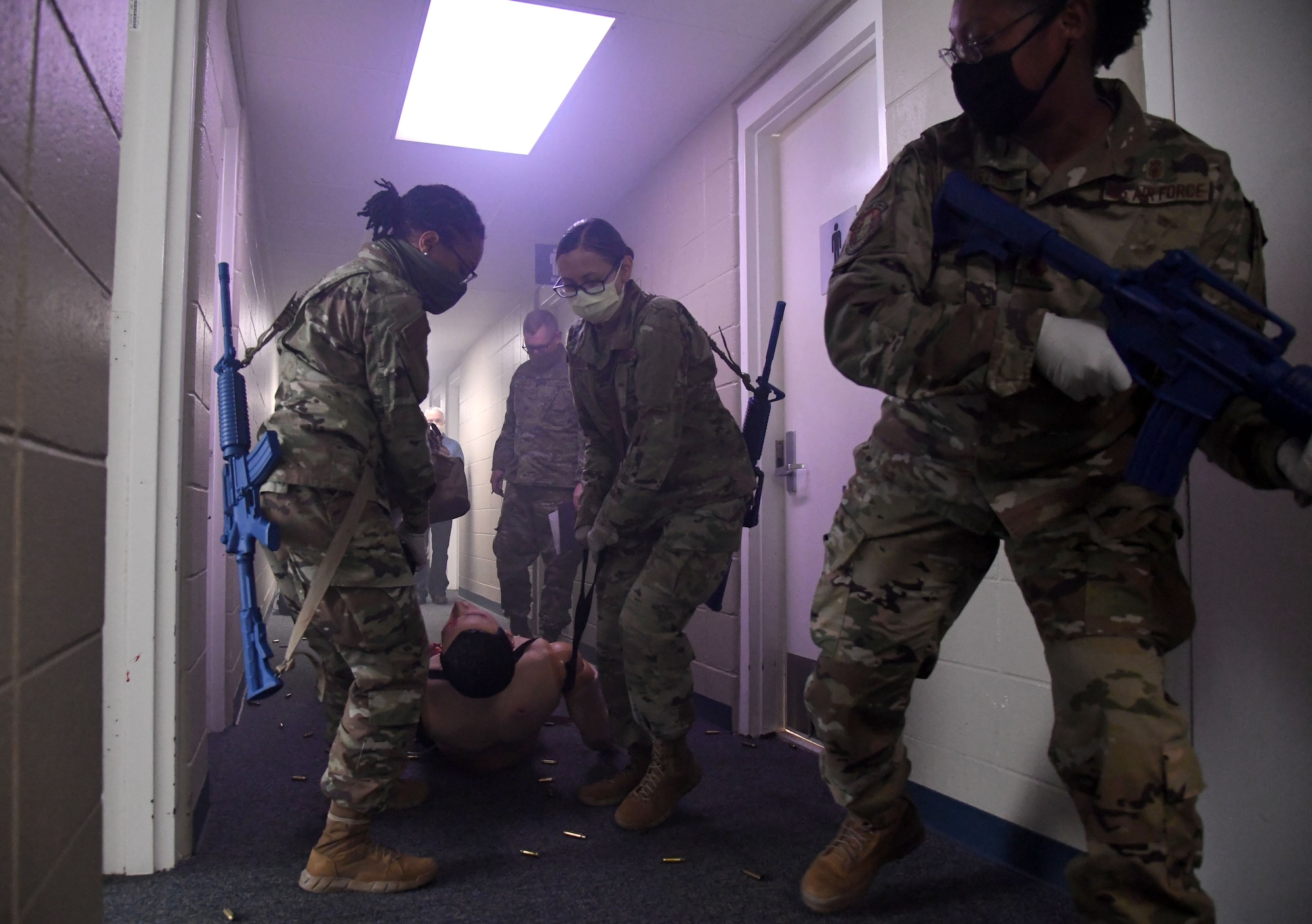 Dragon medics participate in the Tactical Combat Casualty Care training program inside the Locker House at Keesler Air Force Base, Mississippi, March 30, 2021. The training offers hands-on training in a simulated deployed environment using evidence based, life saving techniques and strategies to provide the best trauma care possible on the battlefield. (U.S. Air Force photo by Kemberly Groue)