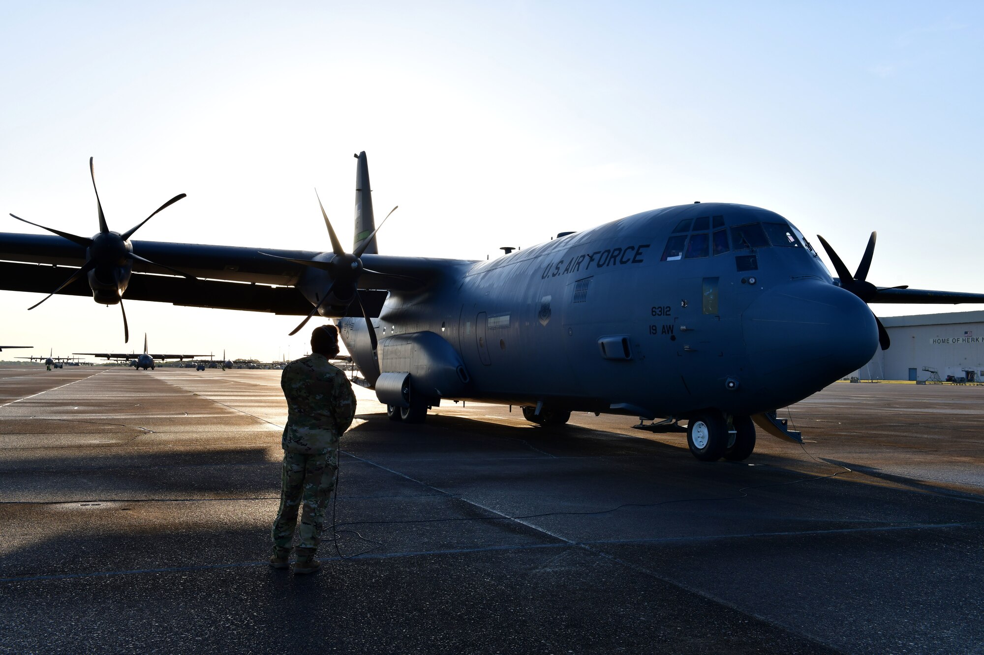 A loadmaster performs final pre-flight checks