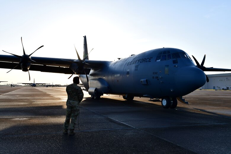 A loadmaster performs final pre-flight checks