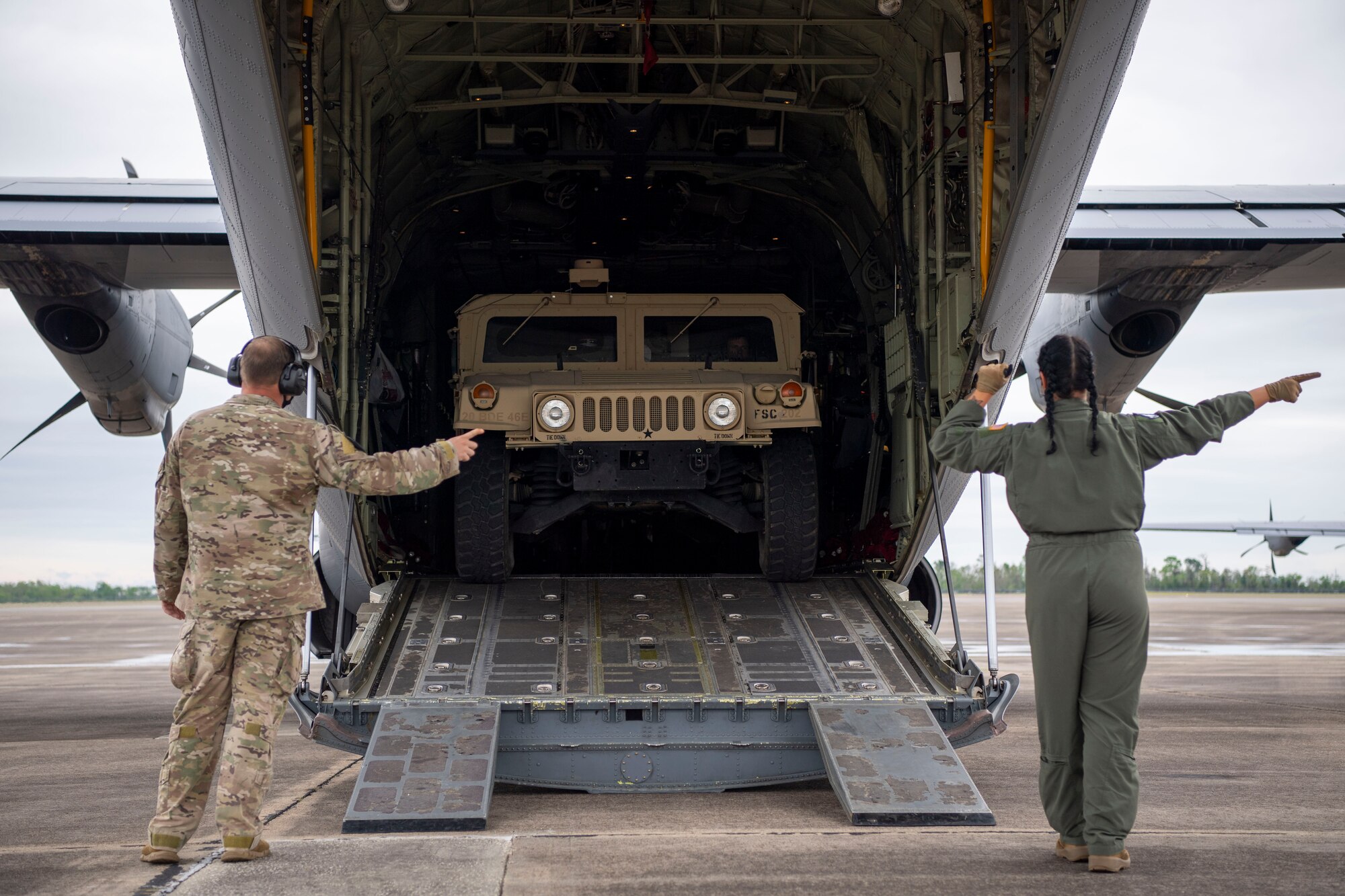 A humvee is loaded onto a C-130J