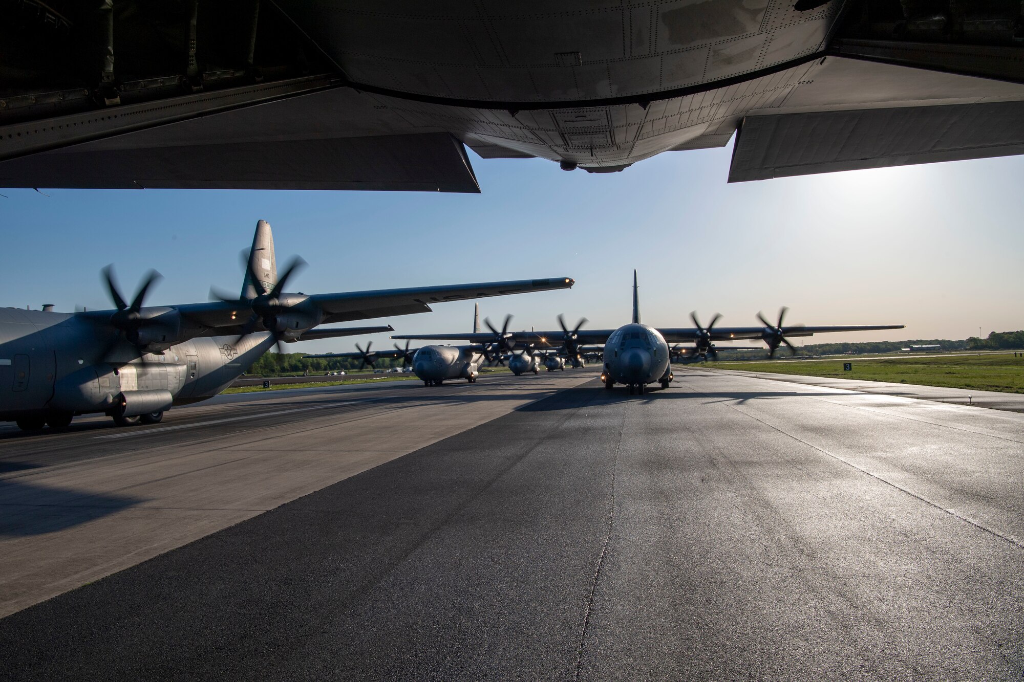 A group of C-130Js prepare for takeoff