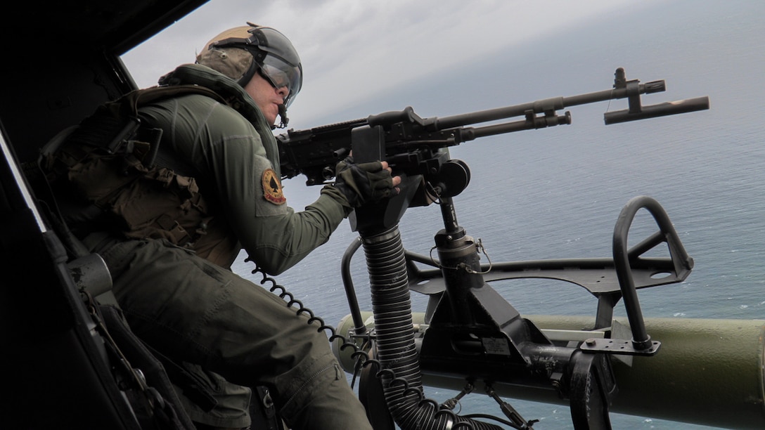 U.S. Marine Corps Gunnery Sgt. Scott Schamber, a UH-1Y Venom crew chief with Marine Light Attack Helicopter Squadron (HMLA) 267, fires an M240D machine gun during live-fire training as part of a mission rehearsal exercise off the coast of Okinawa, Japan, April 14, 2021. The MRX served as a culminating event for HMLA-267 as they near the end of their time in Okinawa as part of the Unit Deployment Program.