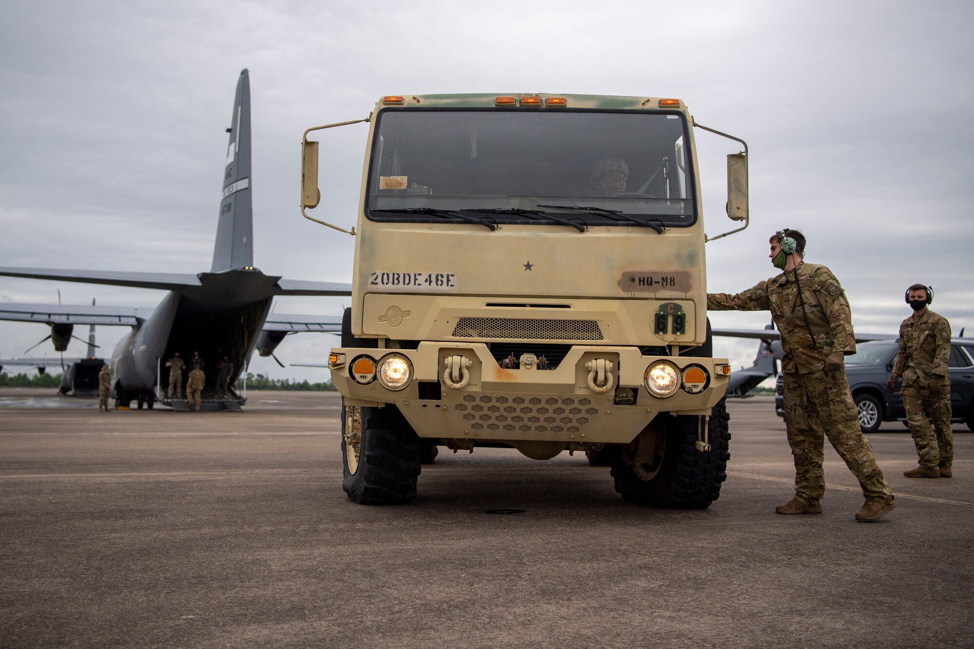 A medium tactical vehicles is loaded on a C-130J