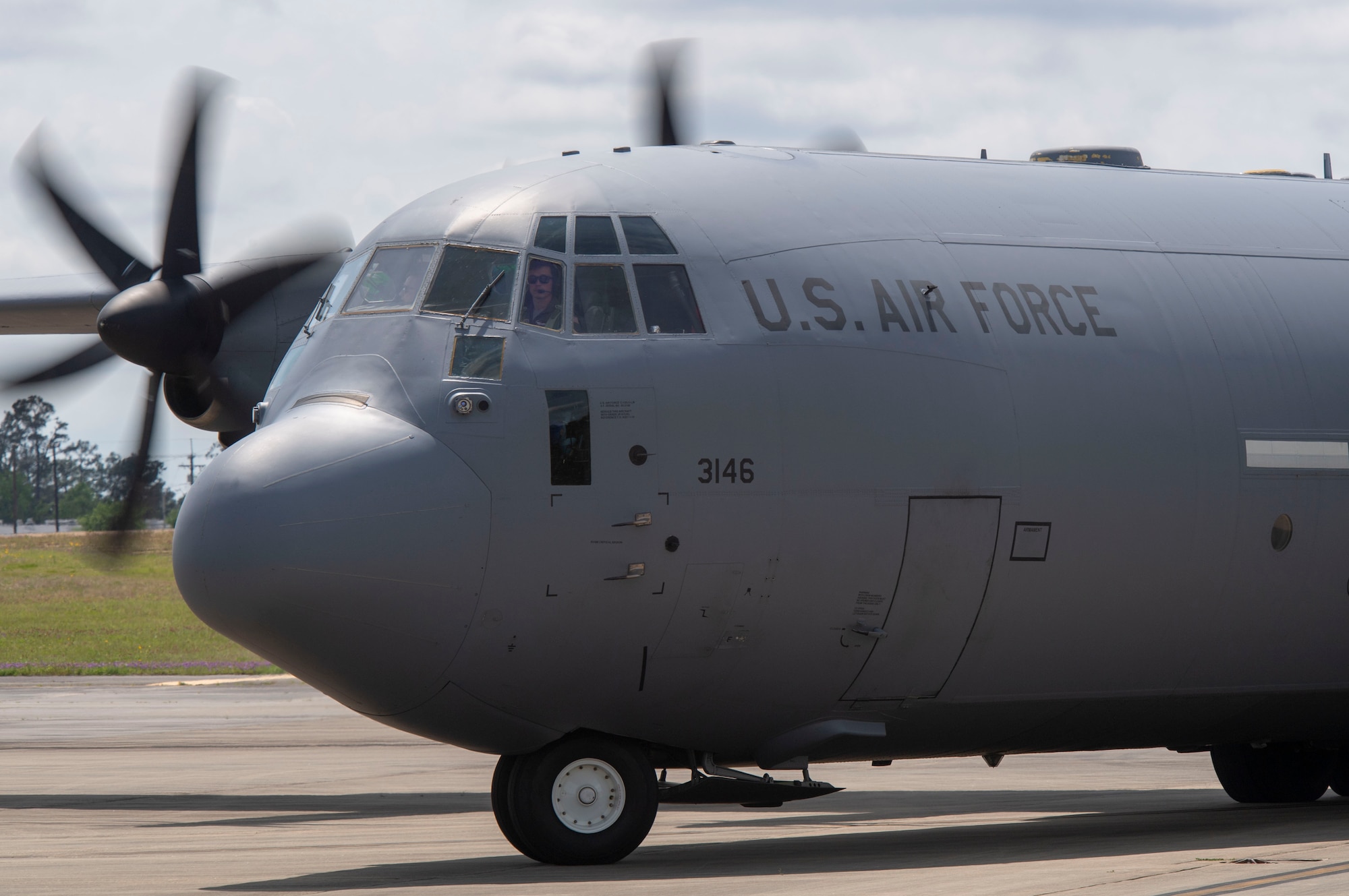 A C-130J taxis on the flightline