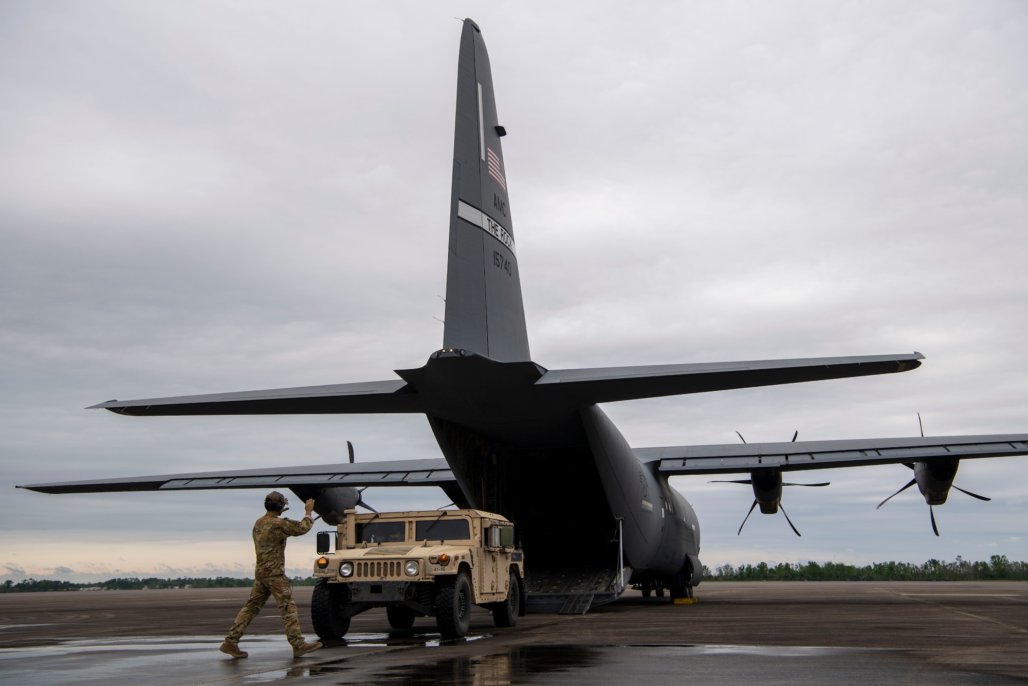 A humvee is loaded onto a C-130J