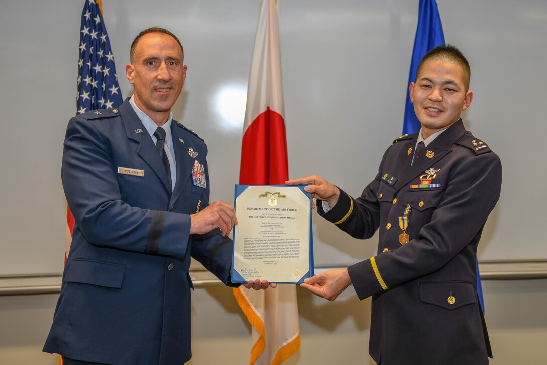 Brig. Gen. Leonard Kosinski presents an Air Force Commendation Medal to Capt. Ryosuke Taki