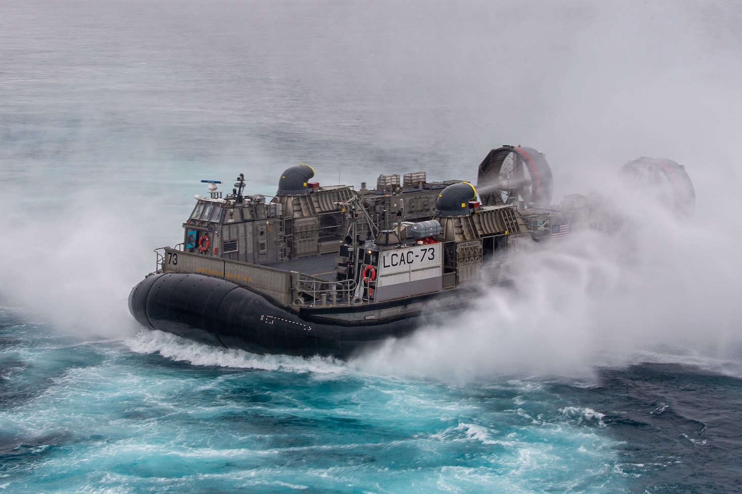 A Landing Craft, Air Cushion (LCAC), attached to Assault Craft Unit (ACU) 5, transits the  Pacific Ocean while conducting well deck operations with amphibious assault ship USS Essex (LHD 2).
