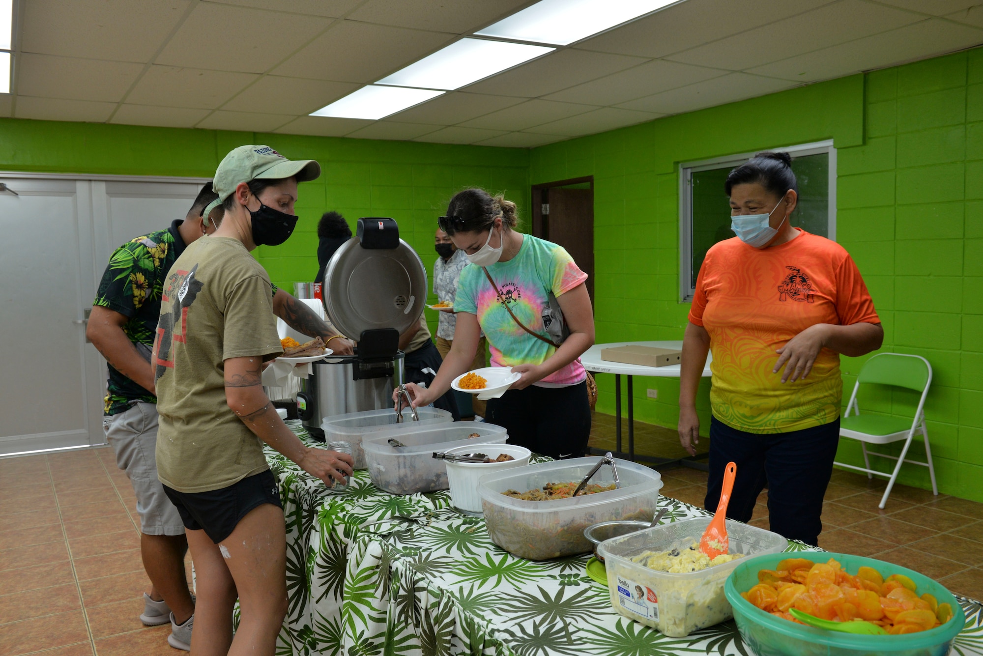 U.S. Air Force Airmen assigned to the 36th Healthcare Operations Squadron join Agat Mayor’s Office staff for a local meal after a bus stop painting event at the mayor’s headquarters in Agat, Guam, March 20, 2021. Nearly a dozen 36th HCOS Airmen and family members joined Agat Mayor’s Office staff to repaint two village bus stops through the Andersen Air Force Base Sister Village Sister Squadron program, in which squadron volunteers collaborate in events with Guam residents to strengthen their friendship and partnership. (U.S. Air Force photo by Alana Chargualaf)