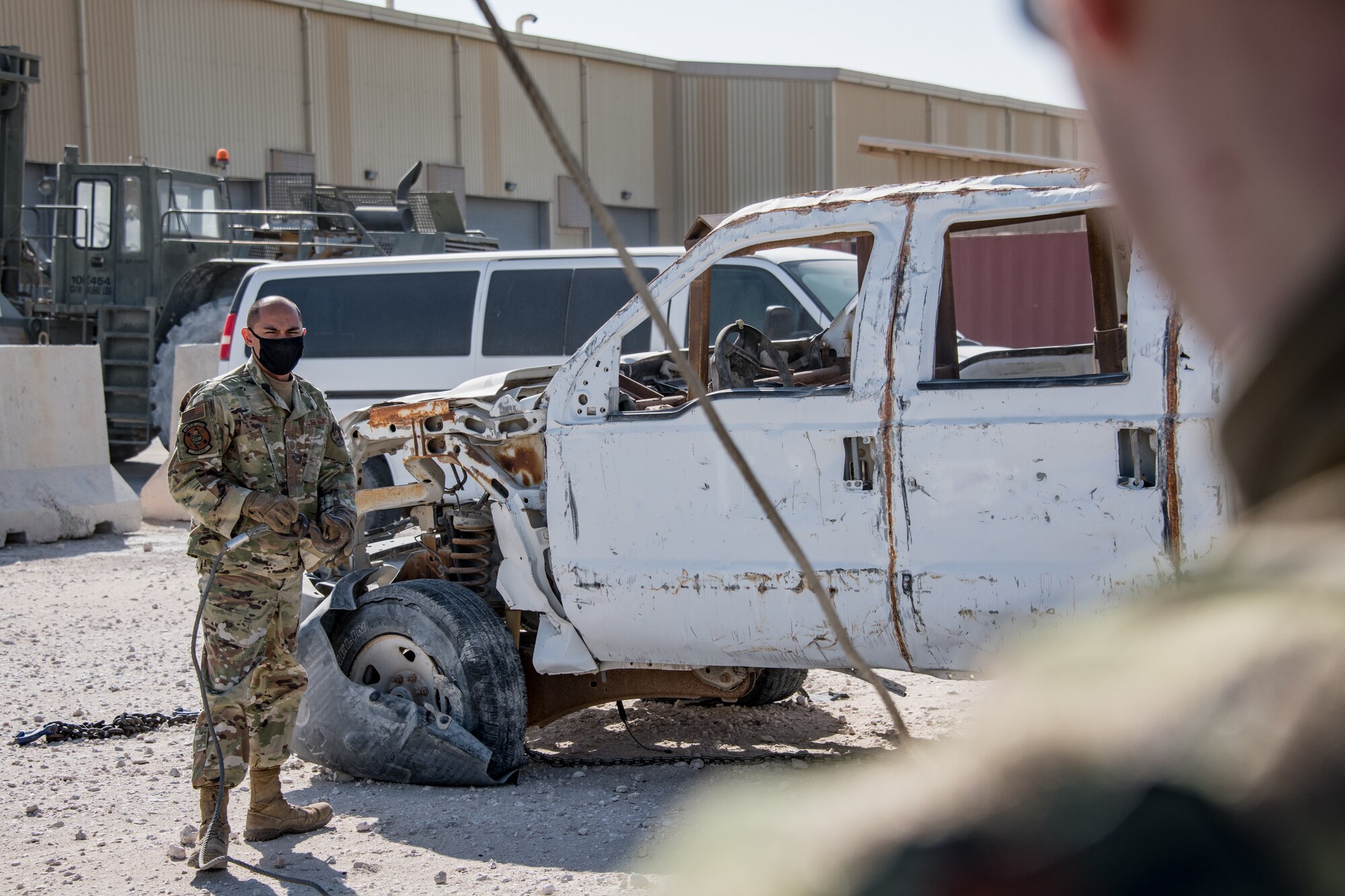 an airman moves toward a wrecked car