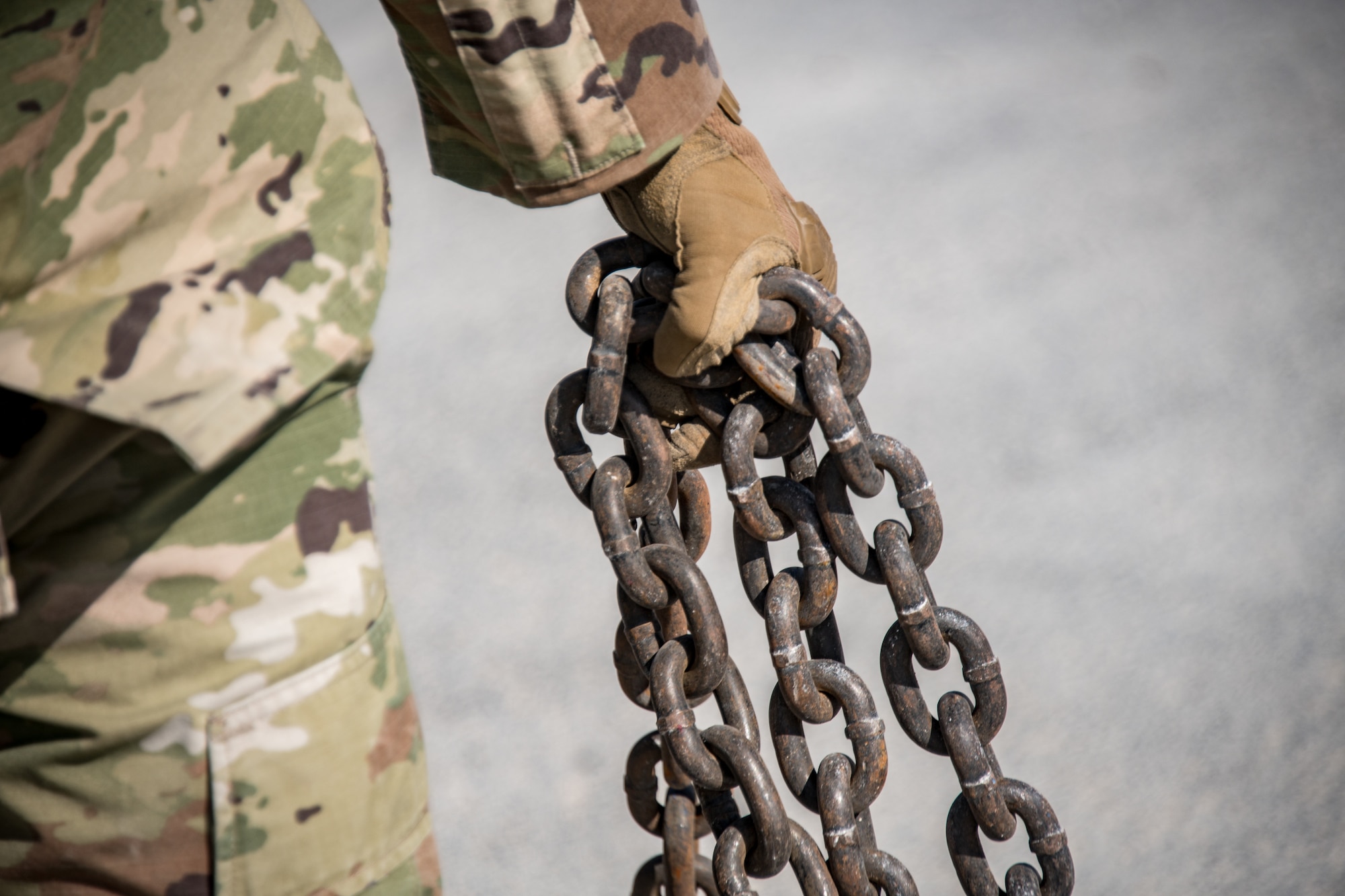 a hand holds a chain