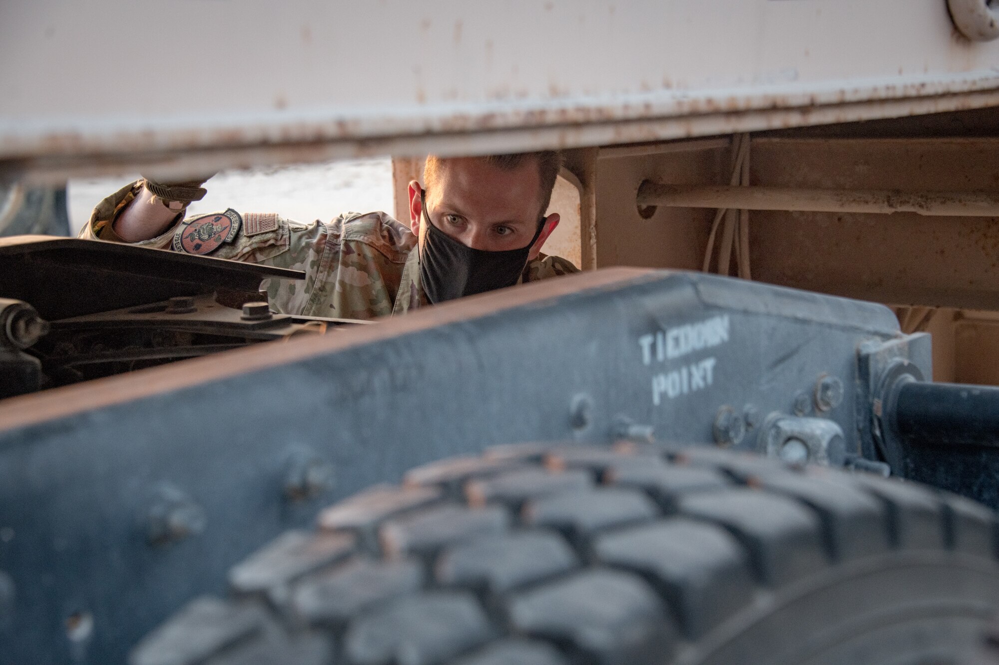 An airman inspects a tractor trailer