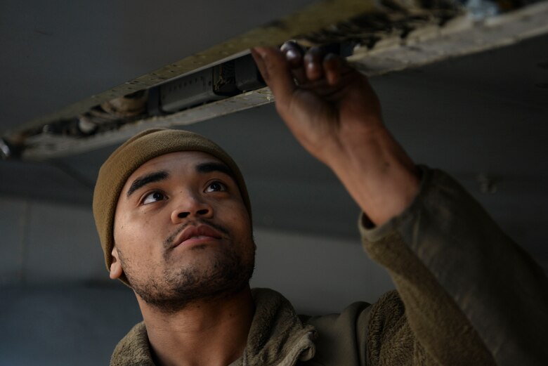 A crew chief examines a jet.